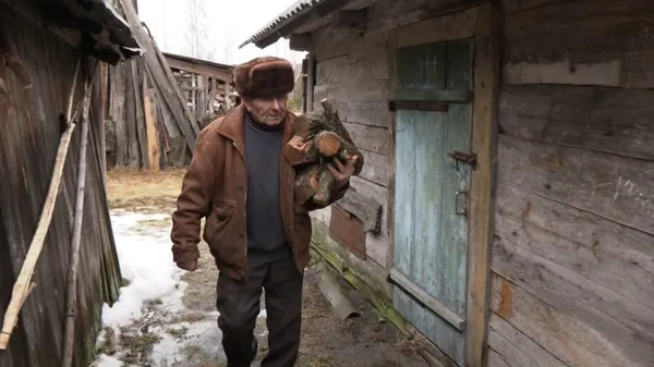 Дрова дід заготовляє сам