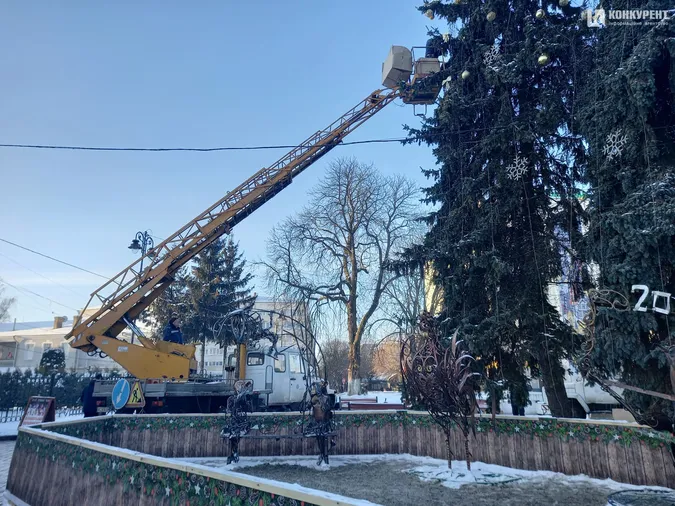 У центрі Луцька з ялинок знімають гірлянди та іграшки (фото)